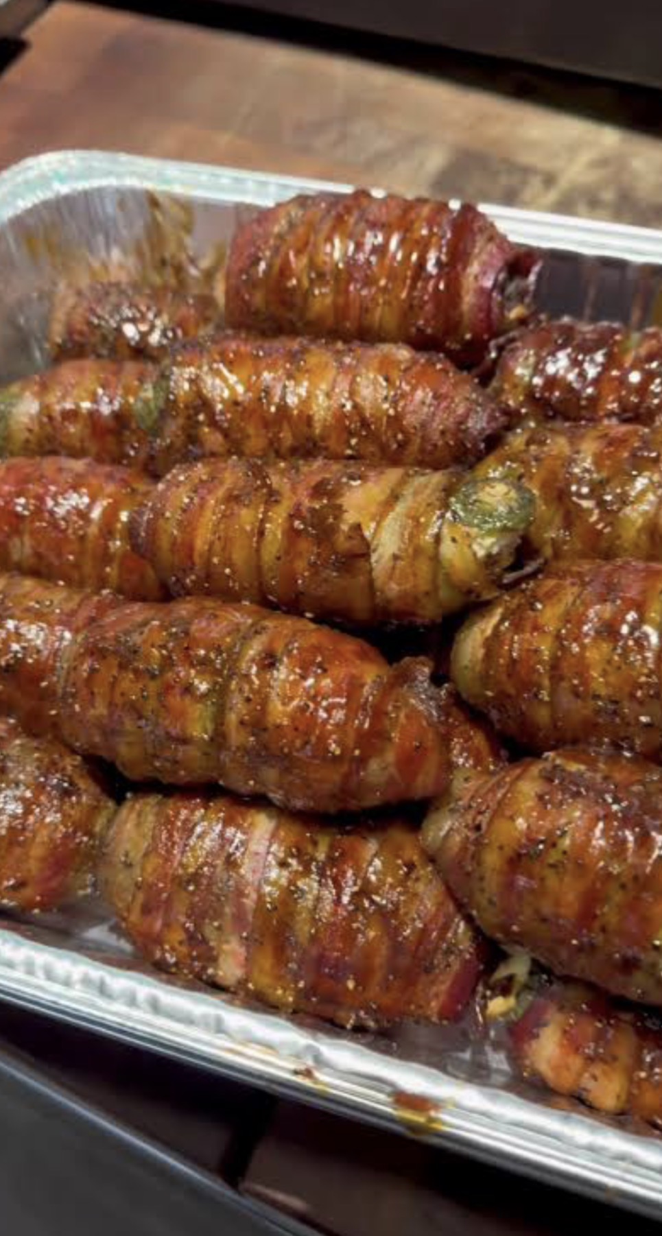 Bacon-wrapped peppers cooking in the smoker
